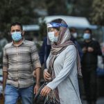 An Iranian woman wearing face mask and shield, after recording the statistics of coronavirus in Iran exceeded 5,500 daily cases and more than 300 deaths a day, walking on a street (COVID19), in Tehran, Iran October 24, 2020. Picture taken October 24, 2020. Majid Asgaripour/WANA (West Asia News Agency)