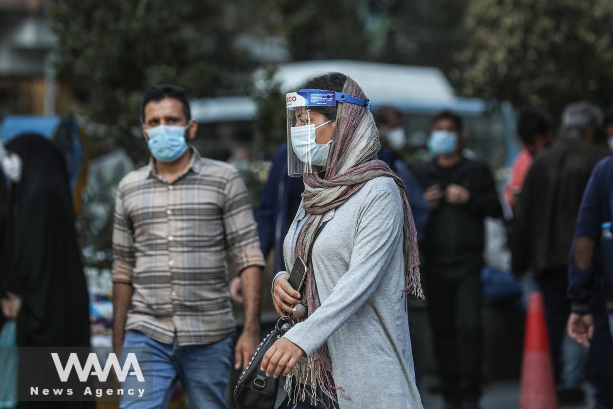 An Iranian woman wearing face mask and shield, after recording the statistics of coronavirus in Iran exceeded 5,500 daily cases and more than 300 deaths a day, walking on a street (COVID19), in Tehran, Iran October 24, 2020. Picture taken October 24, 2020. Majid Asgaripour/WANA (West Asia News Agency)