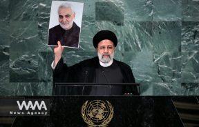 Iran's President Seyed Ebrahim Raisi holds up a picture of Quds Force Commander General Qassem Soleimani, who was assassinated in a U.S. attack, as he addresses the 77th Session of the United Nations General Assembly at U.N. Headquarters in New York City, U.S., September 21, 2022. WANA (West Asia News Agency) / President office