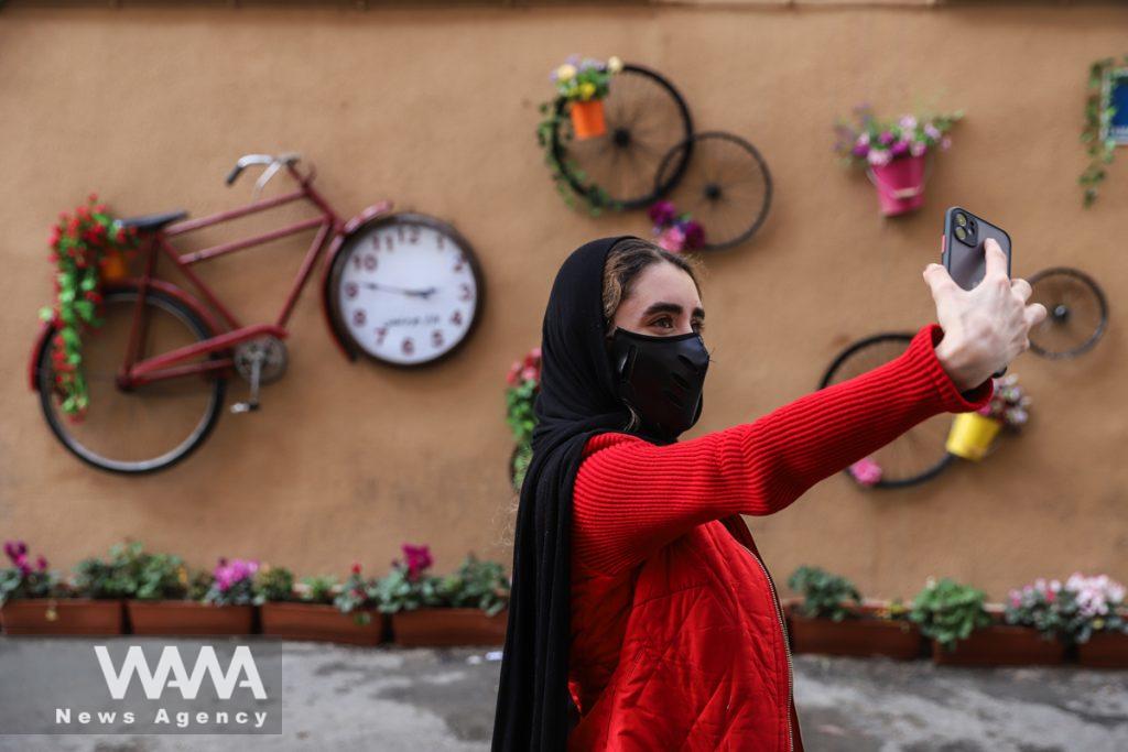 An Iranian girl takes a selfie, ahead of the Iranian New Year Nowruz, March 20, in Tehran, Iran March 10, 2021. Picture taken March 10, 2021. Majid Asgaripour/WANA (West Asia News Agency)