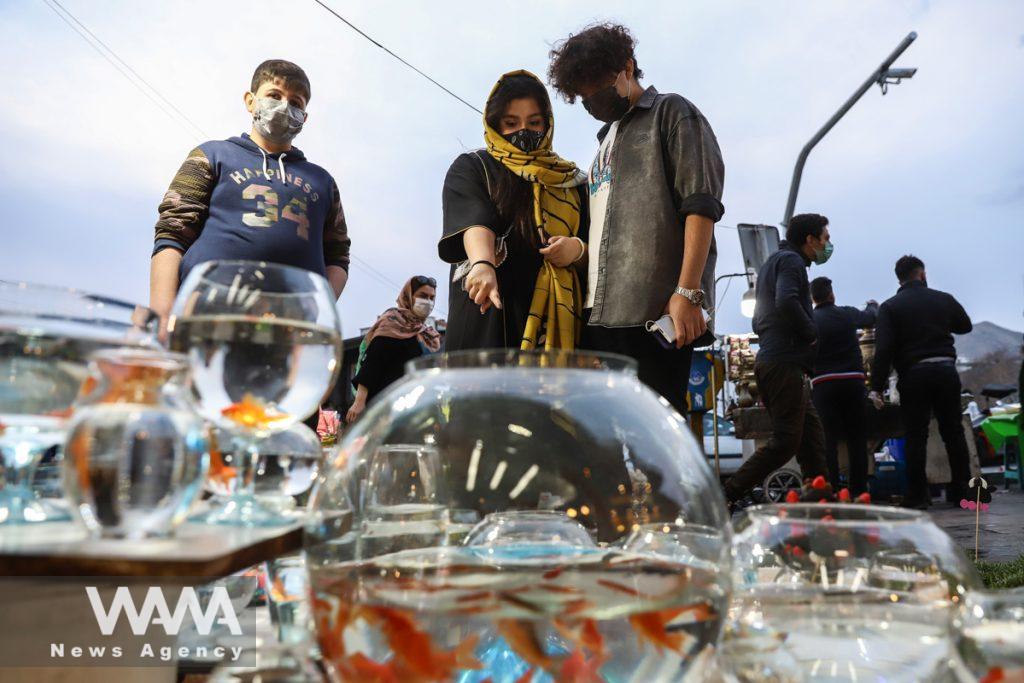 People buy golden fish, ahead of the Iranian New Year Nowruz, March 20, in Tajrish Bazar Tehran, Iran March 10, 2021. Picture taken March 10, 2021. Majid Asgaripour/WANA (West Asia News Agency)