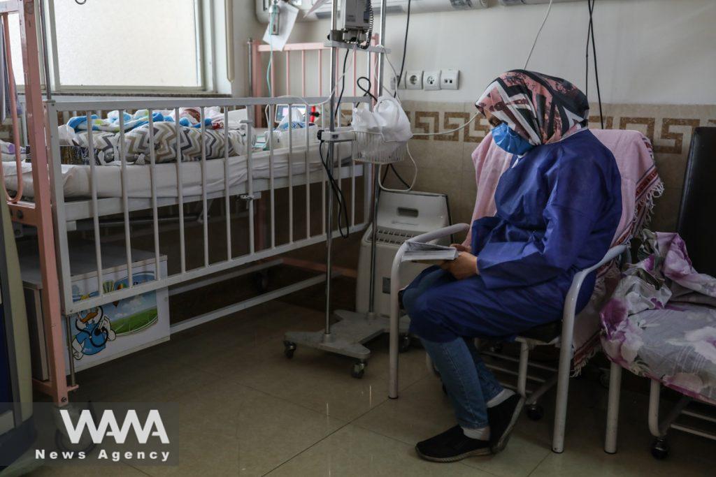 An Iranian mother reading prayers for her child at Hazrate Ali Asghr Hospital in Tehran, Iran September 27, 2020. Majid Asgaripour/WANA (West Asia News Agency)