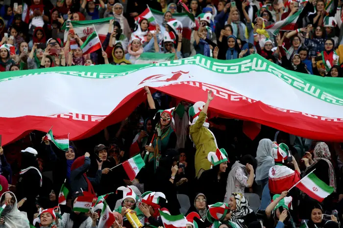 Iranian women cheer the men's national team in Tehran on Oct. 10. 