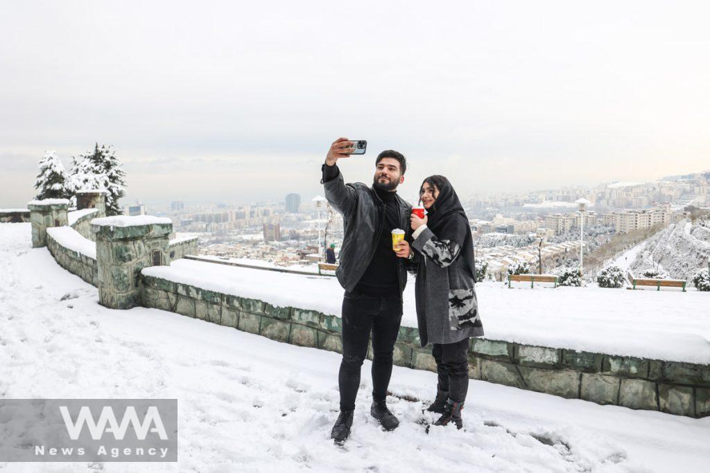 An Iranian couple takes a selfie during the first snowfall in a park in Tehran, Iran December 24, 2022. Majid Asgaripour/WANA (West Asia News Agency)