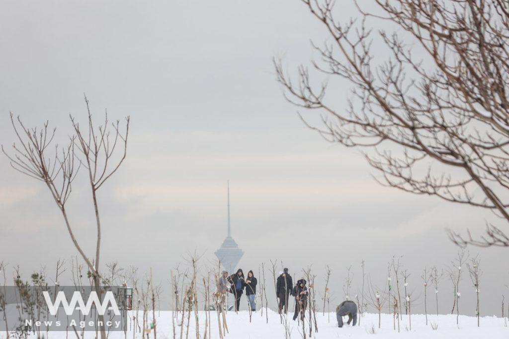 People walk during the first snowfall in a park in Tehran, Iran December 24, 2022. Majid Asgaripour/WANA (West Asia News Agency)