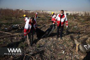 Rescue team carries a body at the site where the Ukraine International Airlines plane crashed after take-off from Iran's Imam Khomeini airport, on the outskirts of Tehran, Iran January 8, 2020. Nazanin Tabatabaee/WANA (West Asia News Agency)