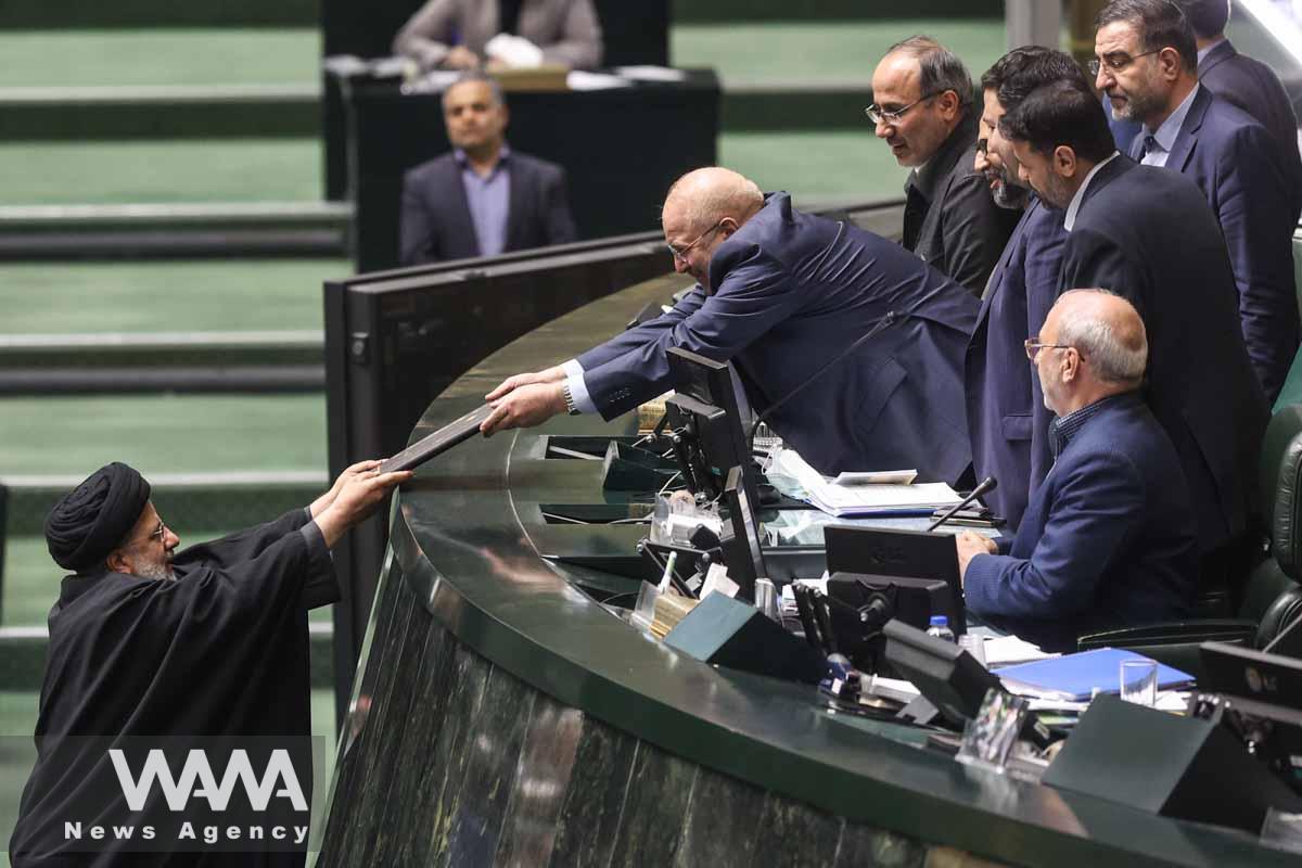 Iranian President Ebrahim Raisi delivers the budget papers to Iranian parliament speaker Mohammad Bagher Ghalibaf during the parliament session in Tehran, Iran, January 11, 2023. Majid Asgaripour/WANA (West Asia News Agency)