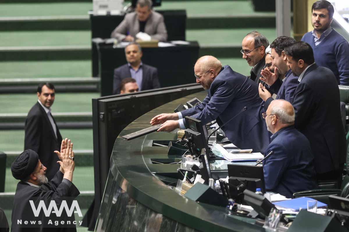 Iranian President Ebrahim Raisi delivers the budget papers to Iranian parliament speaker Mohammad Bagher Ghalibaf during the parliament session in Tehran, Iran, January 11, 2023. Majid Asgaripour/WANA (West Asia News Agency)