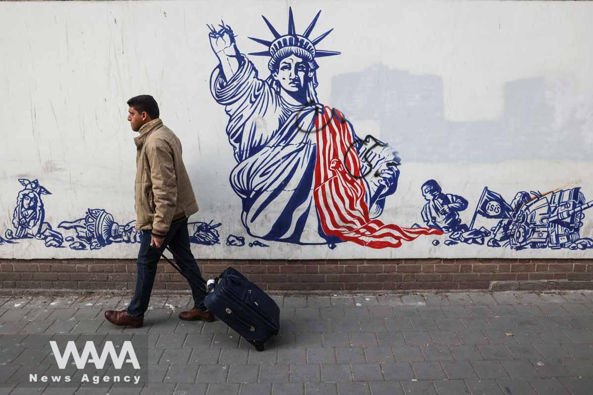An Iranian man walks past an anti-U.S. mural on the wall of former U.S. Embassy in Tehran, Iran January 25, 2023. Majid Asgaripour/WANA (West Asia News Agency)
