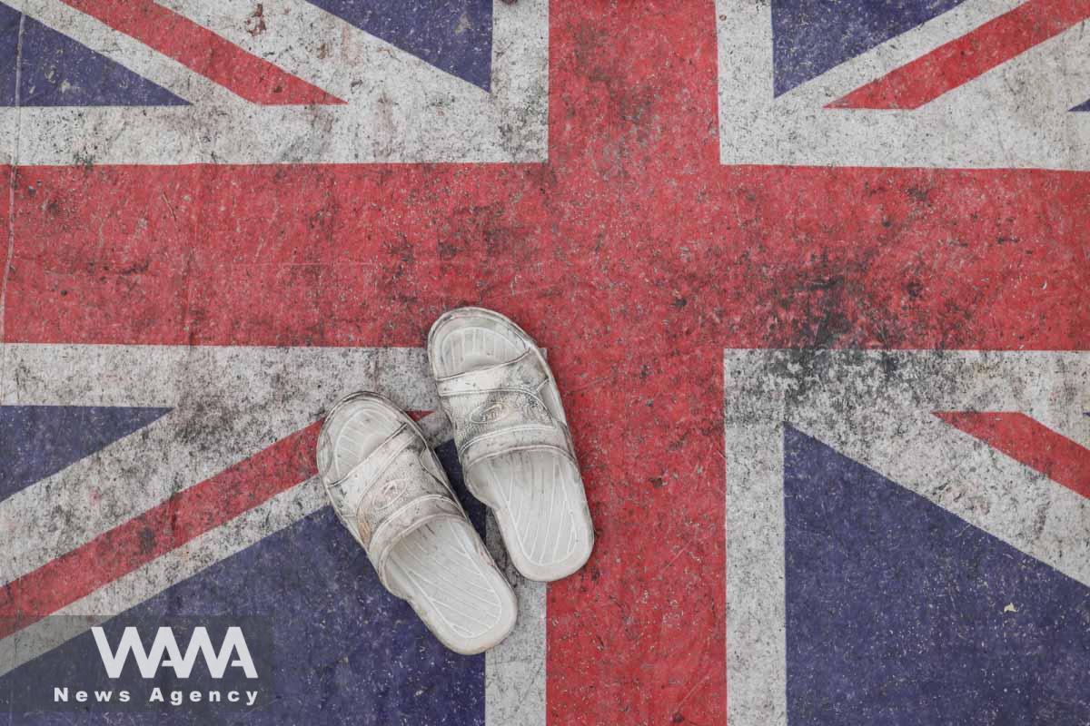 A pair of slippers are seen on the British flag during a protest after Rasmus Paludan, leader of Danish far-right political party burned a copy of the Quran in Sweden, in Tehran, Iran, January 27, 2023. Majid Asgaripour/WANA (West Asia News Agency)