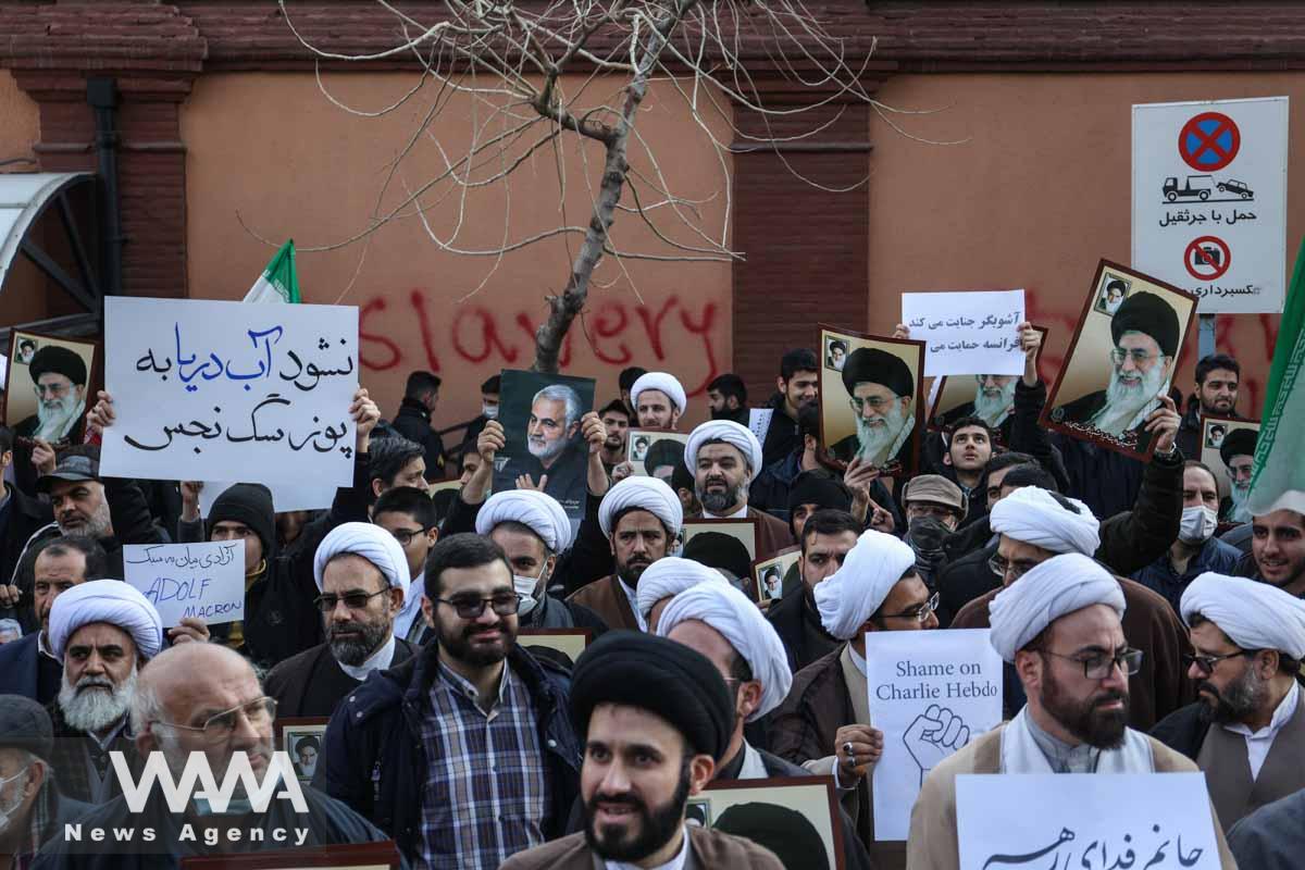 Iranian clerics hold pictures of Ayatollah Ali Khamenei, during a protest to condemn the French magazine Charlie Hebdo for republishing cartoons insulting Iran's Supreme Leader Ayatollah Ali Khamenei, in front of the French Embassy in Tehran, Iran, January 8, 2023. Majid Asgaripour/WANA (West Asia News Agency)
