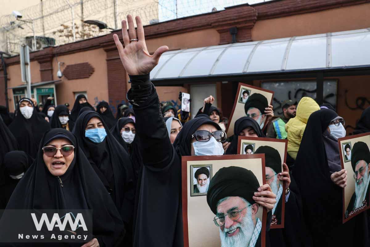 A protester holds a picture of Ayatollah Ali Khamenei, during a protest to condemn the French magazine Charlie Hebdo for republishing cartoons insulting Iran's Supreme Leader Ayatollah Ali Khamenei, in front of the French Embassy in Tehran, Iran, January 8, 2023. Majid Asgaripour/WANA (West Asia News Agency)