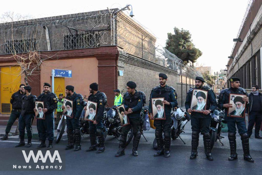 Police forces hold pictures of Ayatollah Ali Khamenei, during a protest to condemn the French magazine Charlie Hebdo for republishing cartoons insulting Iran's Supreme Leader Ayatollah Ali Khamenei, in front of the French Embassy in Tehran, Iran, January 8, 2023. Majid Asgaripour/WANA (West Asia News Agency)