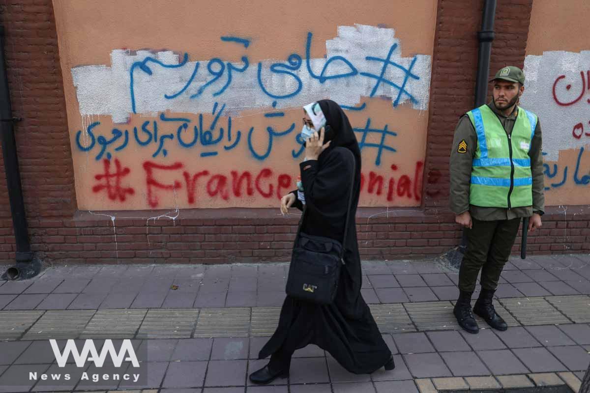 An anti-French graffiti is seen on the wall of the French Embassy in Tehran, during a protest to condemn the French magazine Charlie Hebdo for republishing cartoons insulting Iran's Supreme Leader Ayatollah Ali Khamenei, in front of the French Embassy in Tehran, Iran, January 8, 2023. Majid Asgaripour/WANA (West Asia News Agency)
