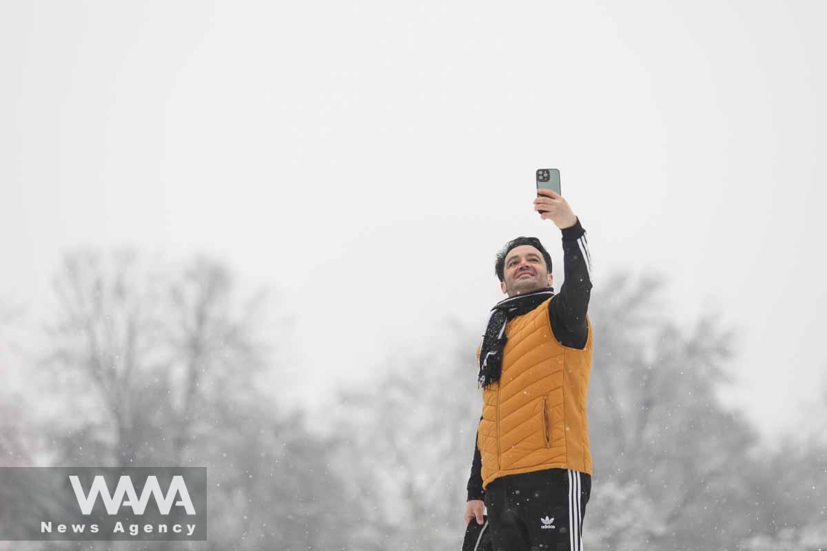 A man takes a selfie during snowfall in Tehran, Iran, January 15, 2023. Majid Asgaripour/WANA (West Asia News Agency)