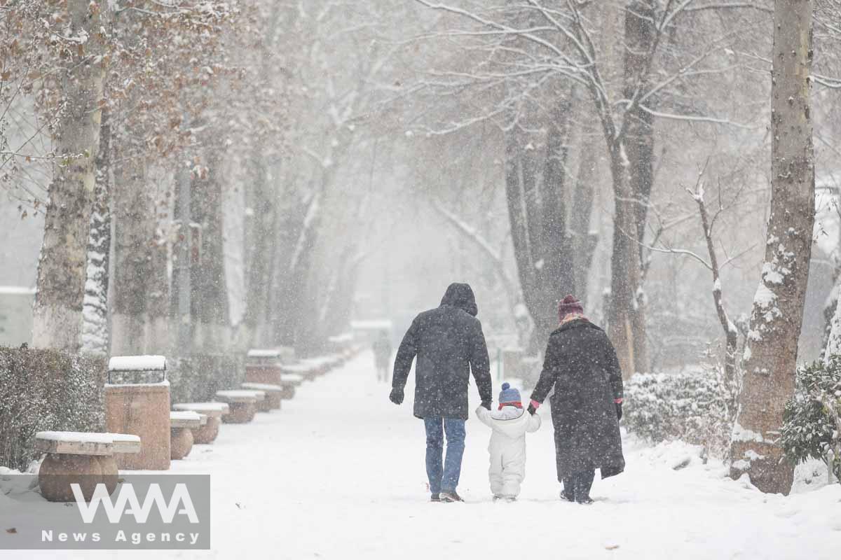 People walk in a park in Tehran during snowfall in Tehran, Iran, January 15, 2023. Majid Asgaripour/WANA (West Asia News Agency)