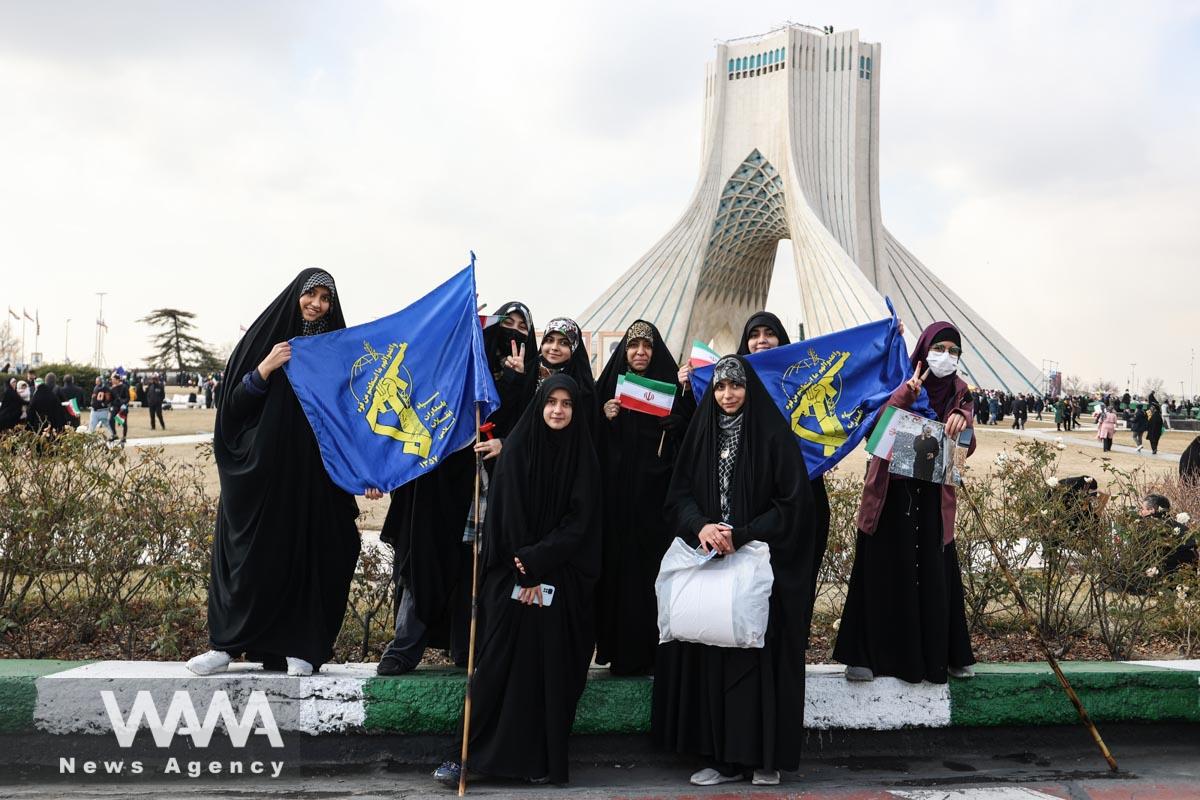 Iranian women hold flags with the IRGC logo during the 44th anniversary of the Islamic Revolution in Tehran, Iran, February 11, 2023. Majid Asgaripour/WANA (West Asia News Agency)