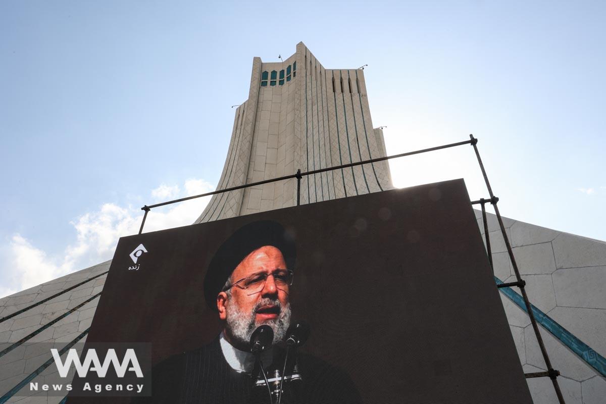 Iranian president Ebrahim Raisi is seen on a display during the 44th anniversary of the Islamic Revolution in Tehran, Iran, February 11, 2023. Majid Asgaripour/WANA (West Asia News Agency)
