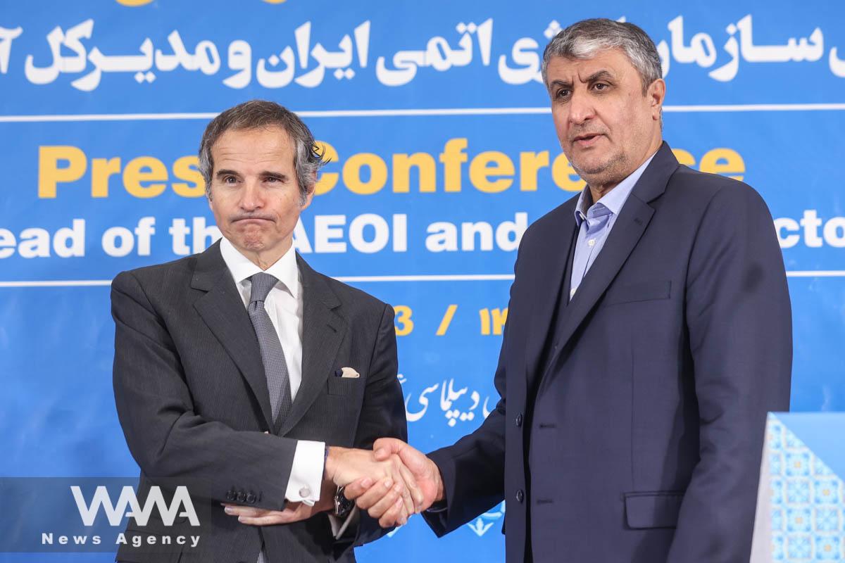 Head of Iran's Atomic Energy Organization Mohammad Eslami and International Atomic Energy Agency (IAEA) Director General Rafael Grossi shake hands after a news conference, in Tehran, Iran, March 4, 2023. Majid Asgaripour/WANA (West Asia News Agency)