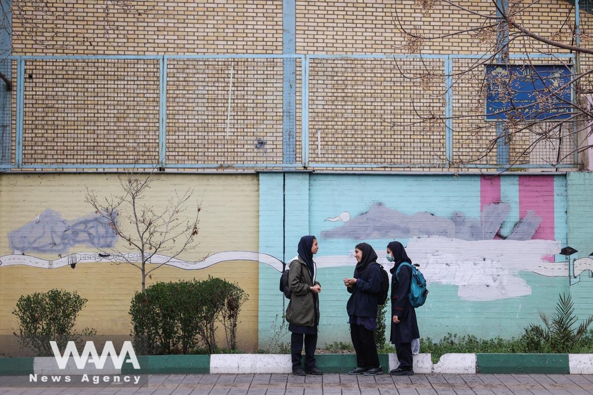 Iranian female students stand in a street in Tehran, Iran, March 7, 2023. Majid Asgaripour/WANA (West Asia News Agency)