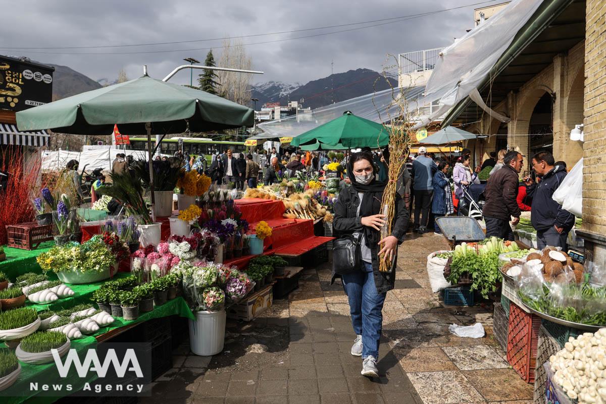 Iranian people walk at the Tajrish Bazaar, ahead of Nowruz, the Iranian New Year, in Tehran, Iran March 15, 2023. Majid Asgaripour/WANA (West Asia News Agency)
