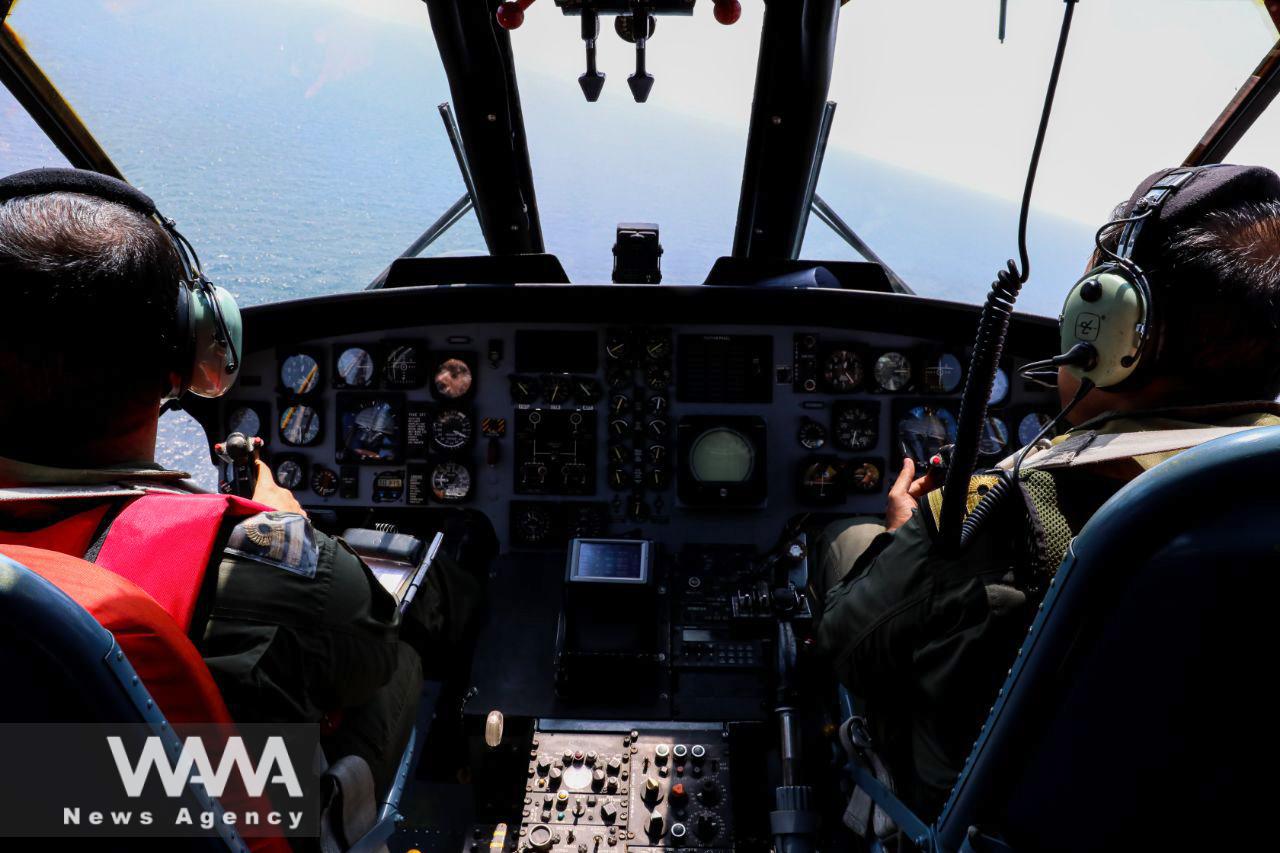 Iranian Army helicopter pilots fly during a joint naval military drill between Iran, Russia, and China in the Gulf of Oman, Iran March 15, 2023. Iranian Army/WANA (West Asia News Agency)