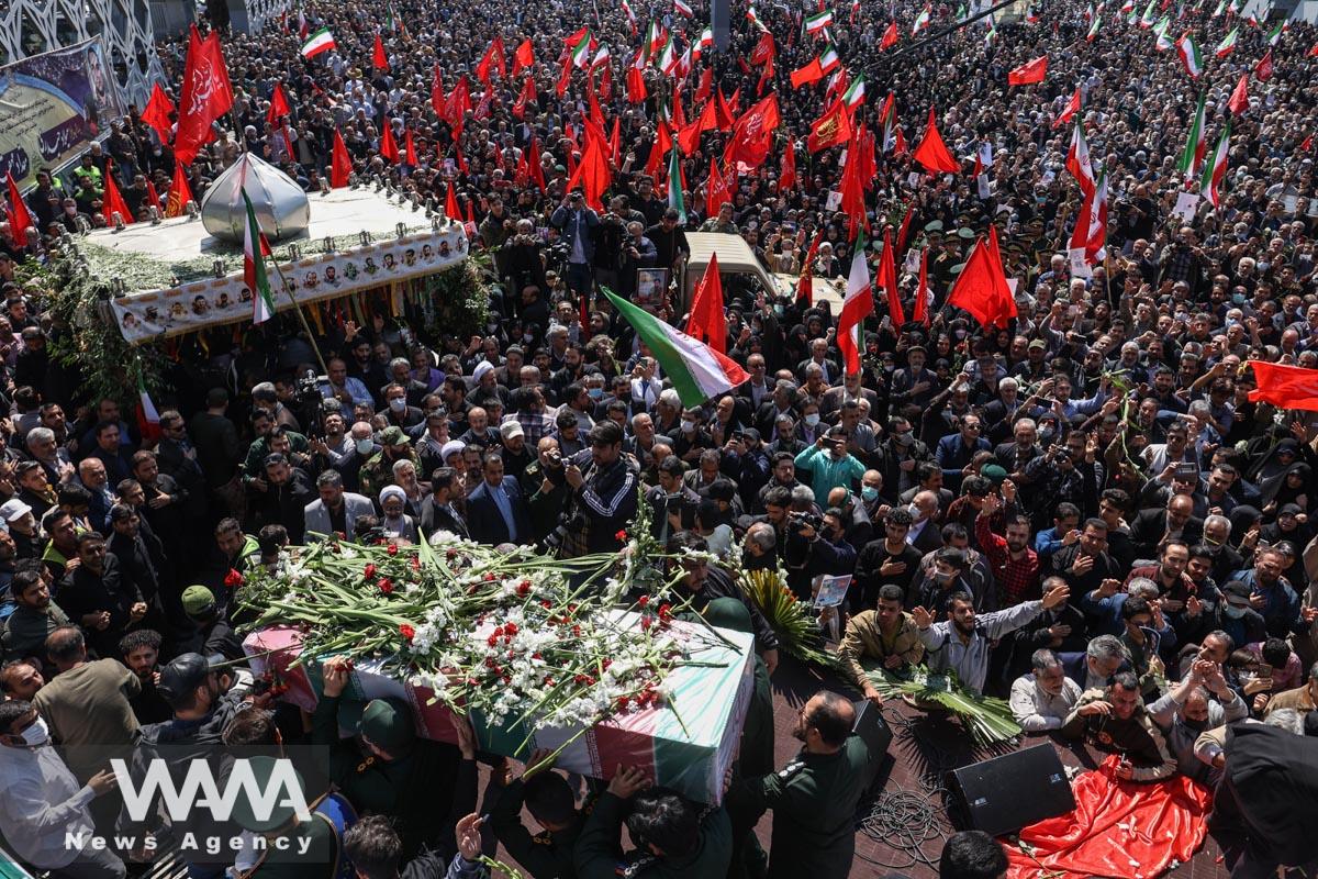 Iranians gather during the funeral ceremony of Milad Heydari and Meghdad Mahghani, members of Iran's Islamic Revolution Guards Corps (IRGC) who were killed in an Israeli airstrike on Damascus, held in Tehran, Iran, April 4, 2023. Majid Asgaripour/WANA (West Asia News Agency)