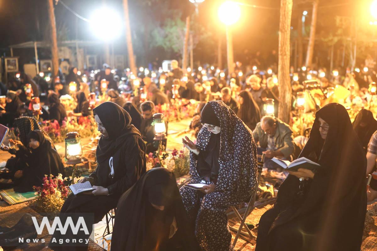 Iranian Shiite Muslims pray in Laylat al-Qadr, during the holy month of Ramadan in Behesht-e-Zahra Cemetery in south of Tehran, Iran, April 10, 2023. Majid Asgaripour/WANA (West Asia News Agency)