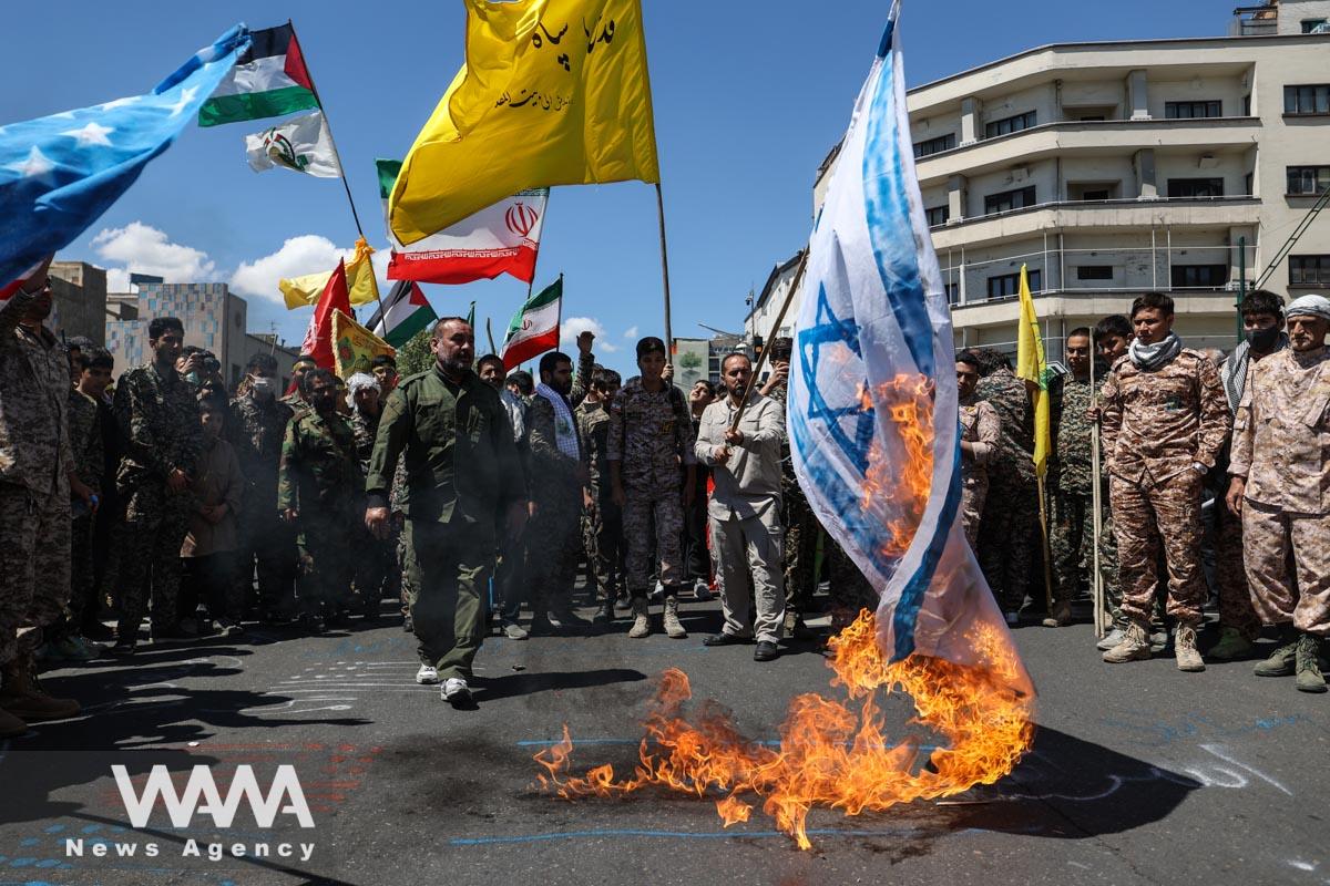 Iranians burn an Israeli flag during a rally marking the annual Quds Day, or Jerusalem Day, on the last Friday of the holy month of Ramadan in Tehran, Iran April 14, 2023. Majid Asgaripour/WANA (West Asia News Agency)