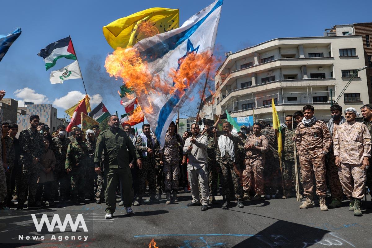 Iranians burn an Israeli flag during a rally marking the annual Quds Day, or Jerusalem Day, on the last Friday of the holy month of Ramadan in Tehran, Iran April 14, 2023. Majid Asgaripour/WANA (West Asia News Agency)