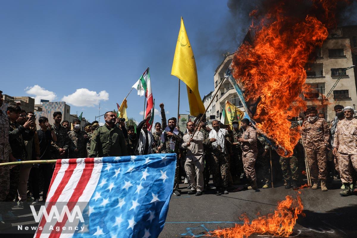 Iranians burn Israeli and U.S. flags during a rally marking the annual Quds Day, or Jerusalem Day, on the last Friday of the holy month of Ramadan in Tehran, Iran April 14, 2023. Majid Asgaripour/WANA (West Asia News Agency)