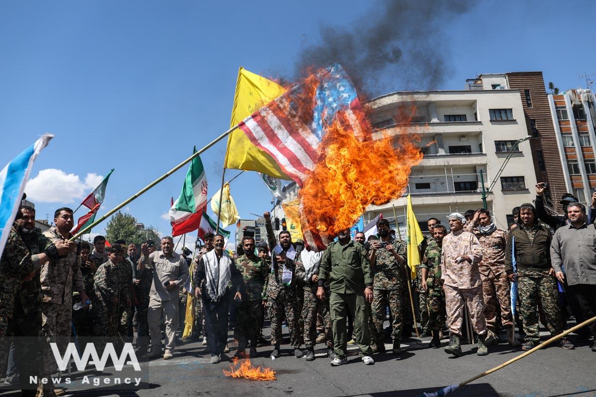 Iranians burn a U.S. flag during a rally marking the annual Quds Day, or Jerusalem Day, on the last Friday of the holy month of Ramadan in Tehran, Iran April 14, 2023. Majid Asgaripour/WANA (West Asia News Agency)