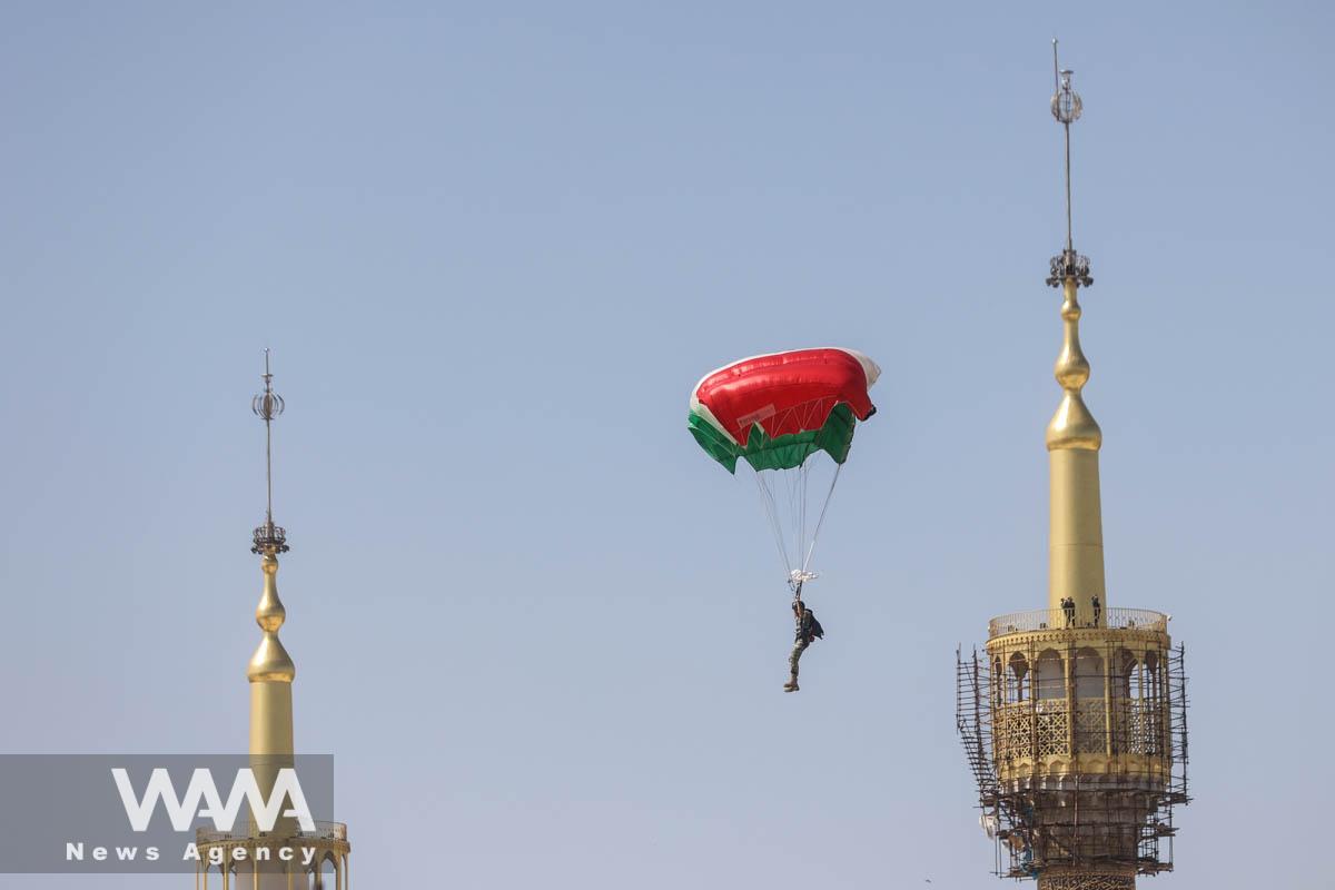 An Iranian paratrooper passes by the tomb of the founder of the Islamic Republic, Ayatollah Ruhollah Khomeini, during a ceremony of the National Army Day parade in Tehran, Iran, April 18, 2023. Majid Asgaripour/WANA (West Asia News Agency)