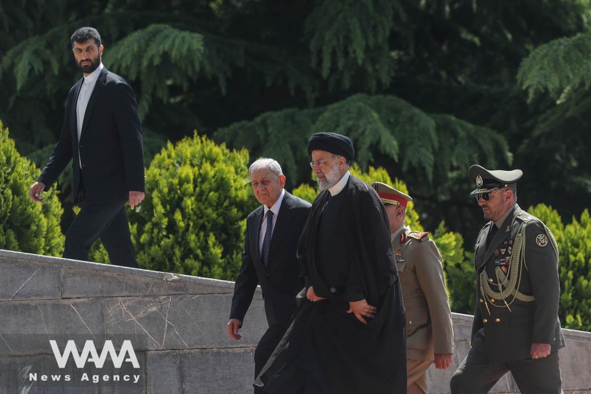 Iranian President Ebrahim Raisi walks with Iraqi President Abdul Latif Rashid during a welcoming ceremony in Tehran, Iran, April 29, 2023. Majid Asgaripour/WANA (West Asia News Agency)