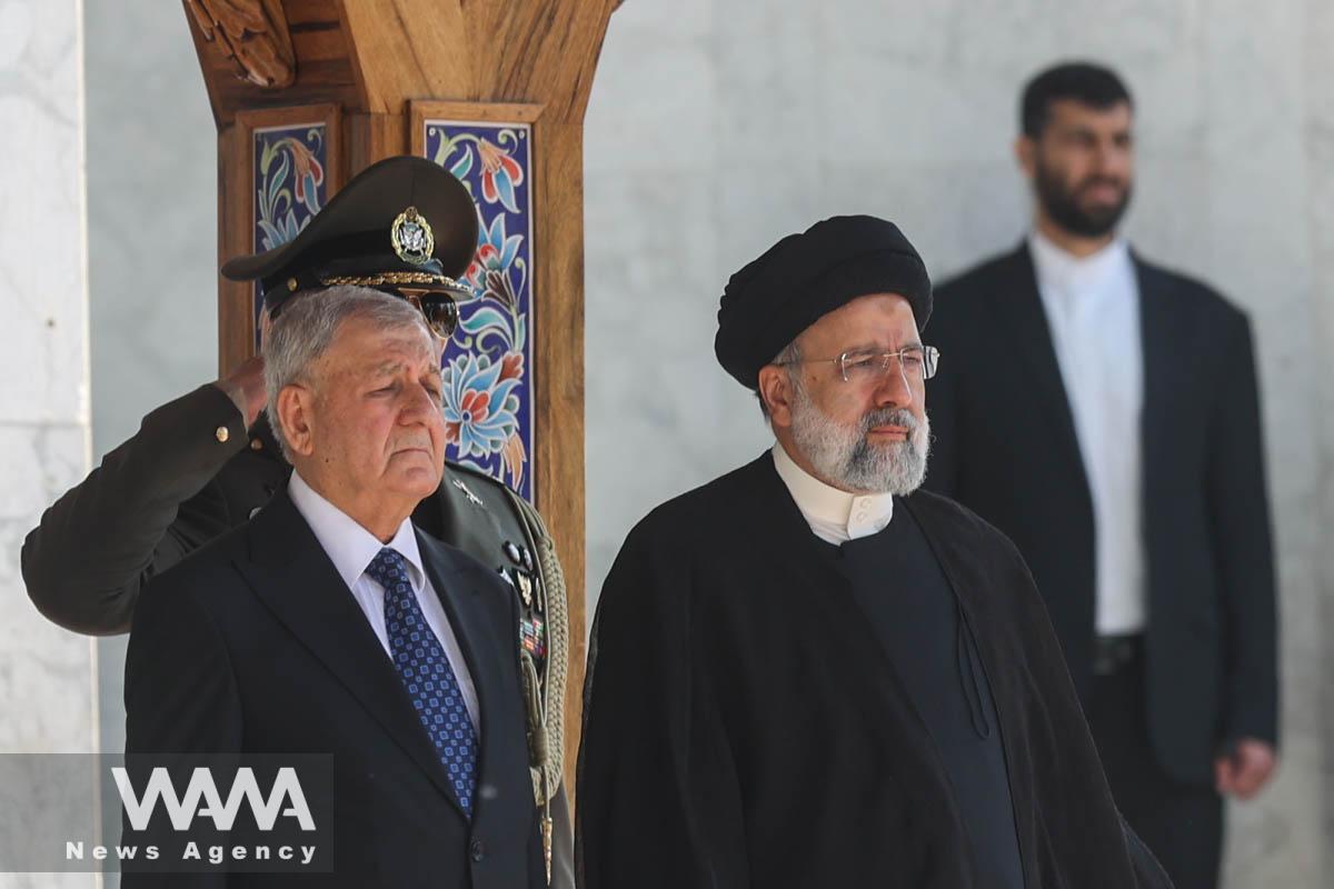 Iranian President Ebrahim Raisi stands next to Iraqi President Abdul Latif Rashid during a welcoming ceremony in Tehran, Iran, April 29, 2023. Majid Asgaripour/WANA (West Asia News Agency)