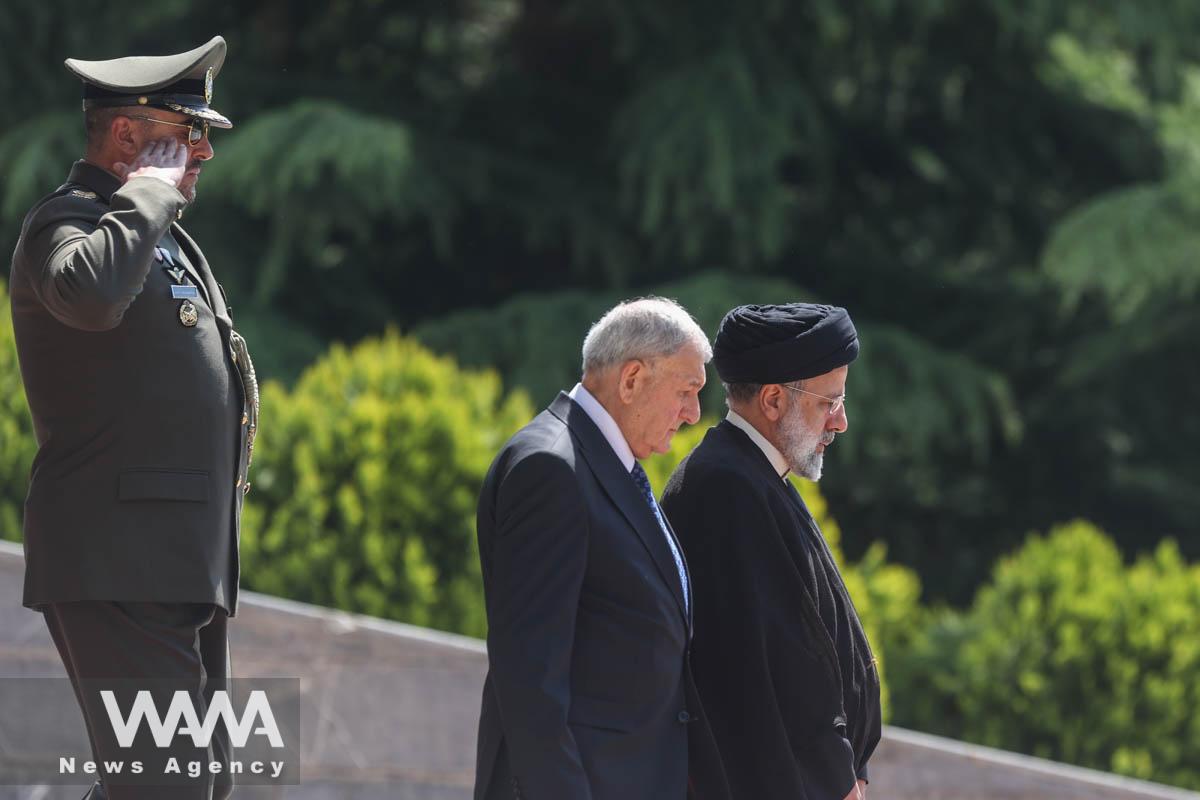 Iranian President Ebrahim Raisi walks with Iraqi President Abdul Latif Rashid during a welcoming ceremony in Tehran, Iran, April 29, 2023. Majid Asgaripour/WANA (West Asia News Agency)