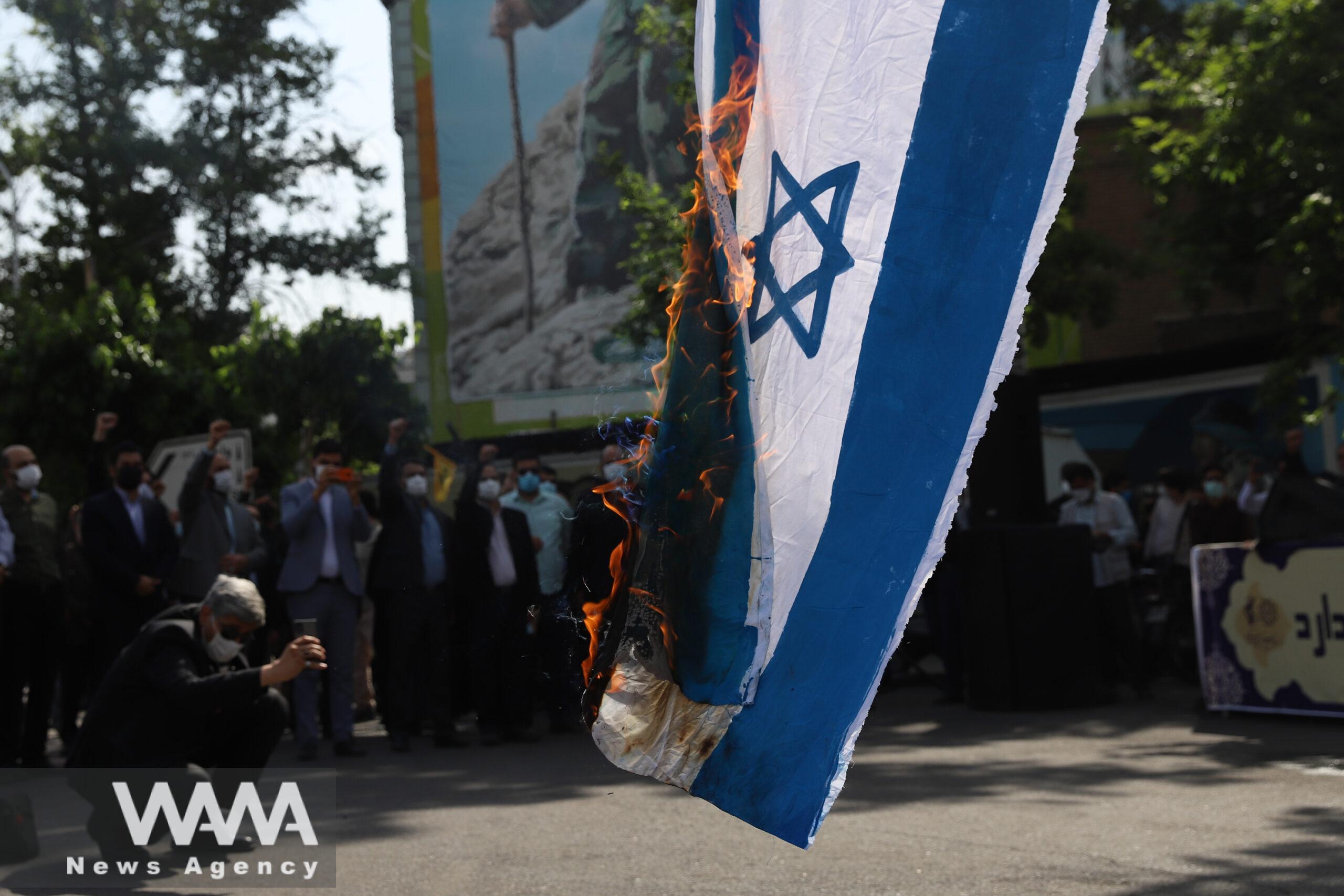Iranians burn an Israeli flag during a rally marking the annual Quds Day, or Jerusalem Day, in Tehran, Iran May 7, 2021.