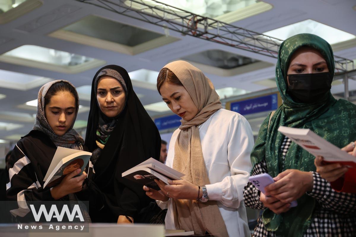 Iranian women read books during the International Book Fair in Tehran, Iran, May 12, 2023. Majid Asgaripour/WANA (West Asia News Agency)
