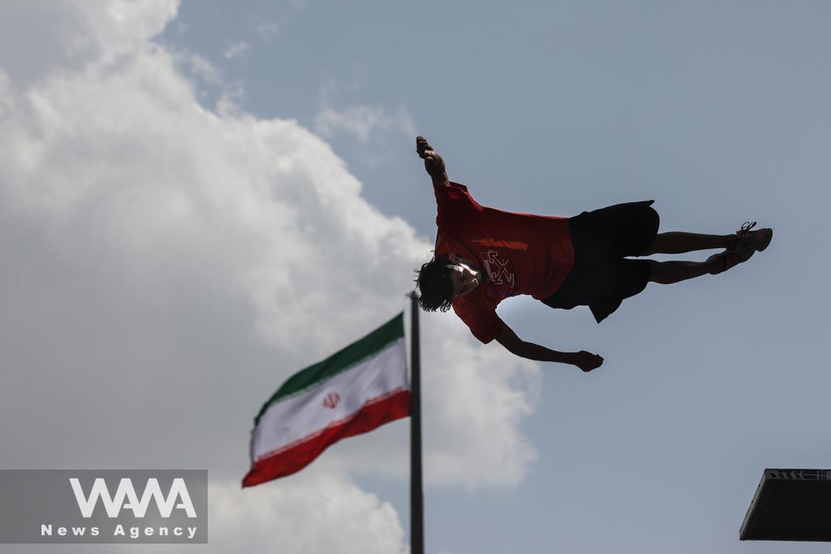An Iranian man jumps during a street diving competition at the Adrenaline Park in Tehran, Iran June 1, 2023. Majid Asgaripour/WANA (West Asia News Agency)