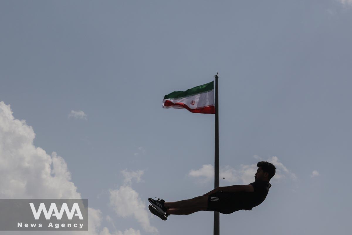 An Iranian man jumps during a street diving competition at the Adrenaline Park in Tehran, Iran June 1, 2023. Majid Asgaripour/WANA (West Asia News Agency)