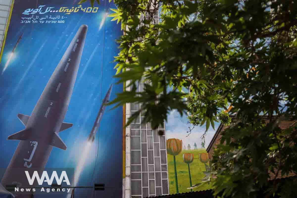 A billboard with a photo of a new hypersonic ballistic missile called "Fattah" and with text reading "400 seconds to Tel Aviv" is seen on a building in Tehran, Iran June 8, 2023. Majid Asgaripour/WANA (West Asia News Agency)