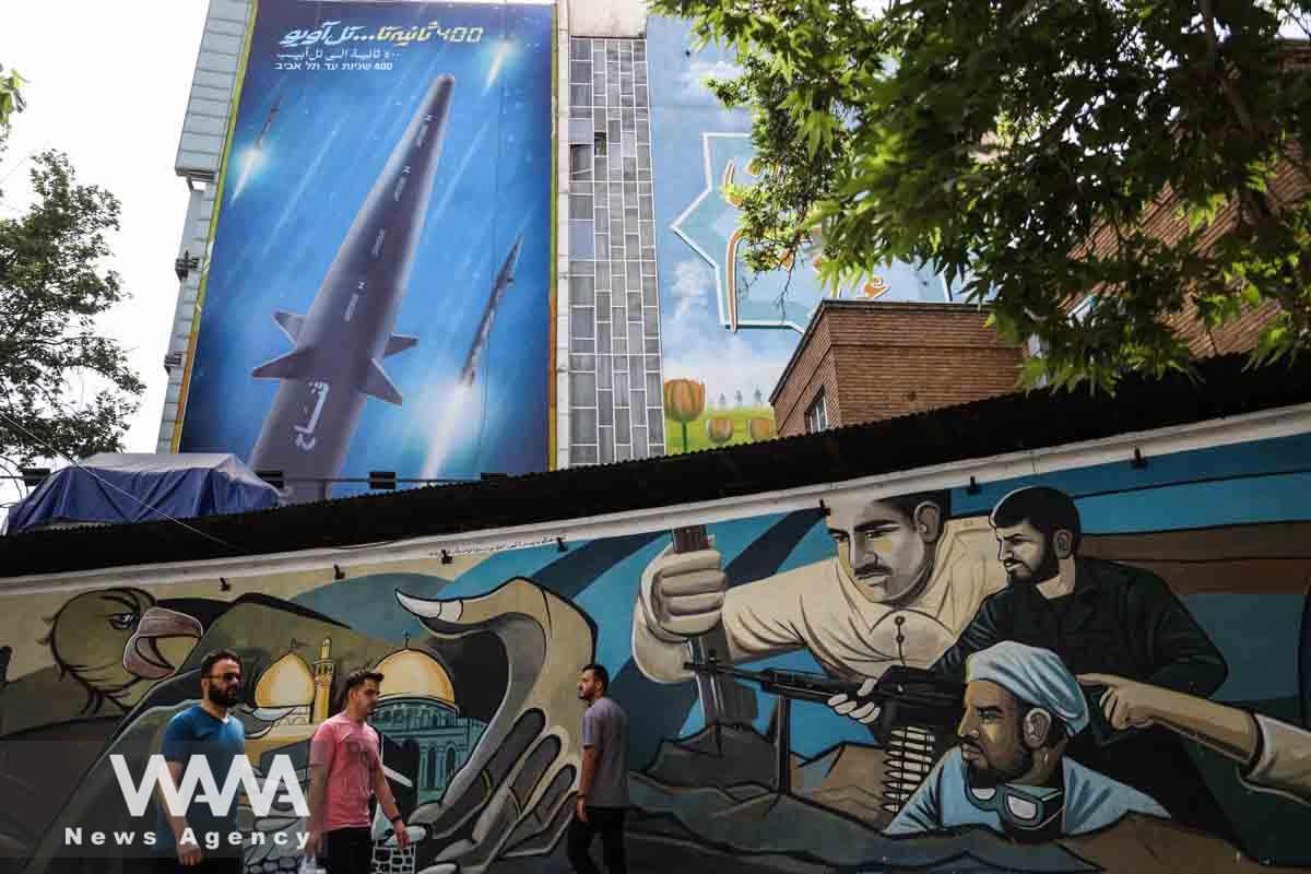 A billboard with a photo of a new hypersonic ballistic missile called "Fattah" and with text reading "400 seconds to Tel Aviv" is seen on a building in Tehran, Iran June 8, 2023. Majid Asgaripour/WANA (West Asia News Agency)