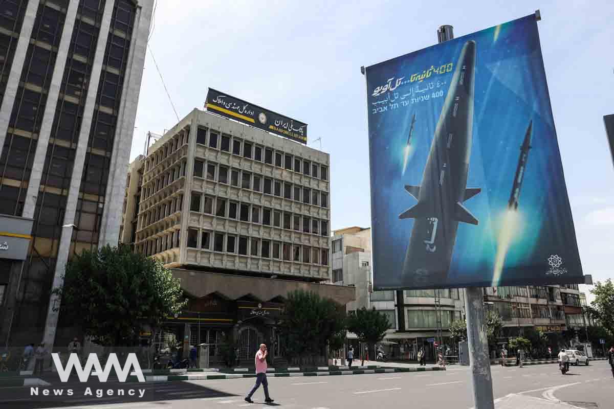 A banner with a photo of a new hypersonic ballistic missile called "Fattah" and with text reading "400 seconds to Tel Aviv" is seen in a street in Tehran, Iran June 8, 2023. Majid Asgaripour/WANA (West Asia News Agency)