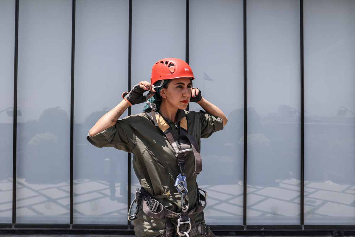 An Iranian female Sogand Salari wears her helmet as she gets ready to clean windows of highrise buildings in Tehran, Iran June 20, 2023. Majid Asgaripour/WANA (West Asia News Agency)