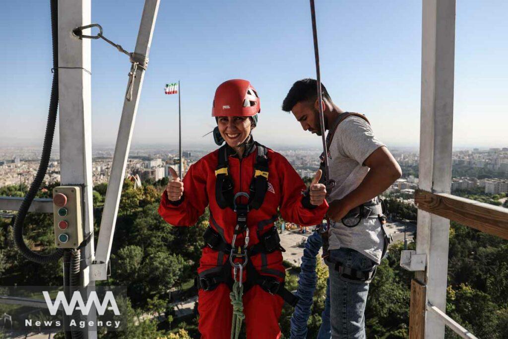 An Iranian female Sogand Salari gives thumbs up as she gets strapped for her bungee-jumping experience, at Adrenaline Park in Tehran, Iran June 21, 2023. Majid Asgaripour/WANA (West Asia News Agency)