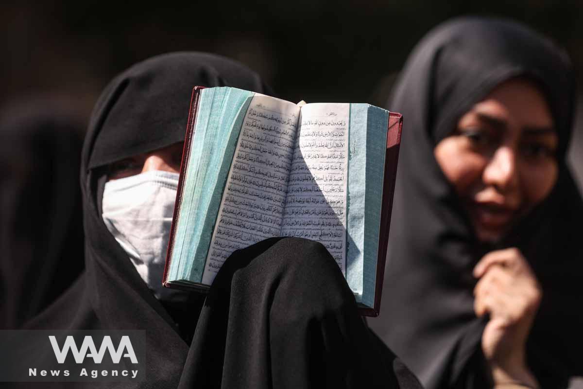 An Iranian protester holds the Quran in her hand during a protest against a man who burned a copy of the Quran outside a mosque in the Swedish capital Stockholm, in front of the Swedish Embassy in Tehran, Iran June 30, 2023. Majid Asgaripour/WANA (West Asia News Agency)