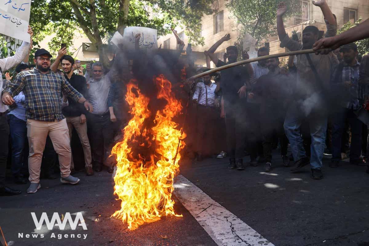 Demonstrators burn the Sweden flag during a protest against a man who burned a copy of the Quran outside a mosque in the Swedish capital Stockholm, in front of the Swedish Embassy in Tehran, Iran June 30, 2023. Majid Asgaripour/WANA (West Asia News Agency)
