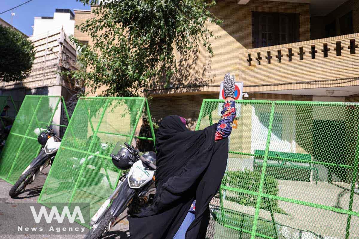 A female protester throws eggs at the Swedish embassy building during a protest against a man who burned a copy of the Quran outside a mosque in the Swedish capital Stockholm, in front of the Swedish Embassy in Tehran, Iran June 30, 2023. Majid Asgaripour/WANA (West Asia News Agency)