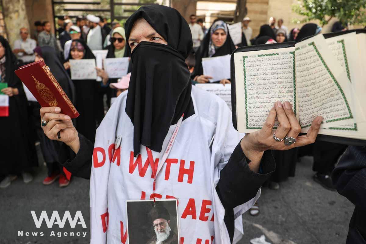 An Iranian protester holds the Quran in her hand during a protest against a man who burned a copy of the Quran outside a mosque in the Swedish capital Stockholm, in front of the Swedish Embassy in Tehran, Iran July 3, 2023. Majid Asgaripour/WANA (West Asia News Agency)