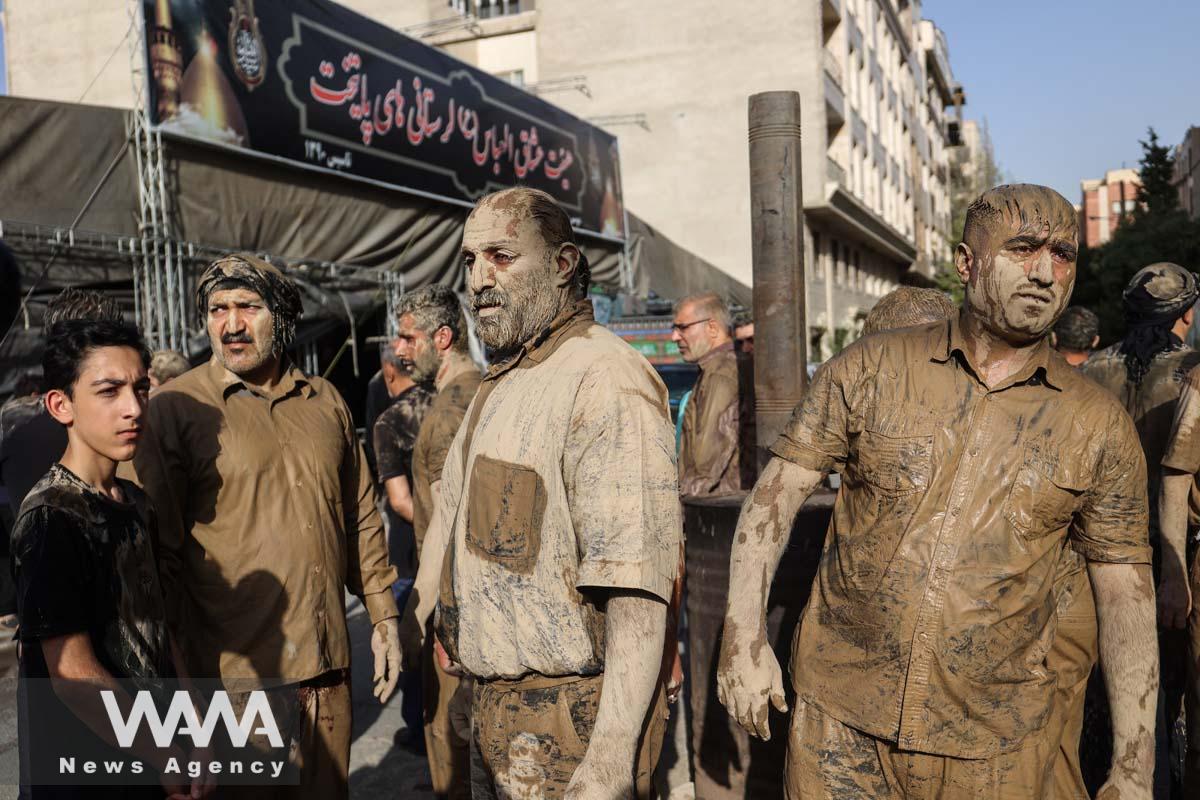 Iranian Shi'ite Muslims mourn after covering themselves with mud during a ceremony to mark Ashura, the holiest day on the Shi'ite Muslim calendar, in Tehran, Iran July 28, 2023. Majid Asgaripour/WANA (West Asia News Agency)
